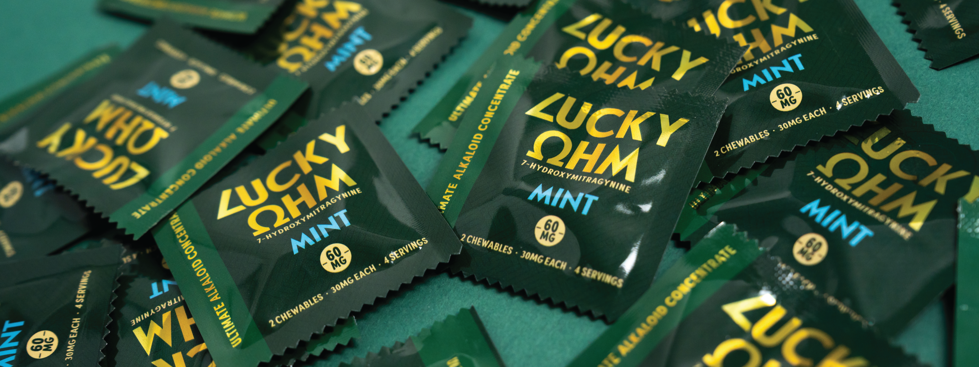 Multiple packages of Lucky Ohm Mint candy on a green background